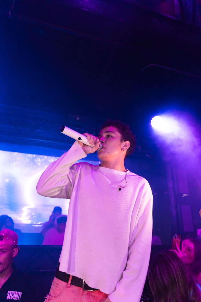 A live performer on the mic with the LED wall behind