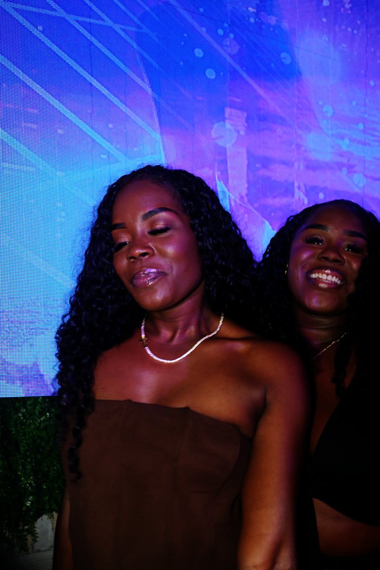 Two friends dancing in front of the LED wall