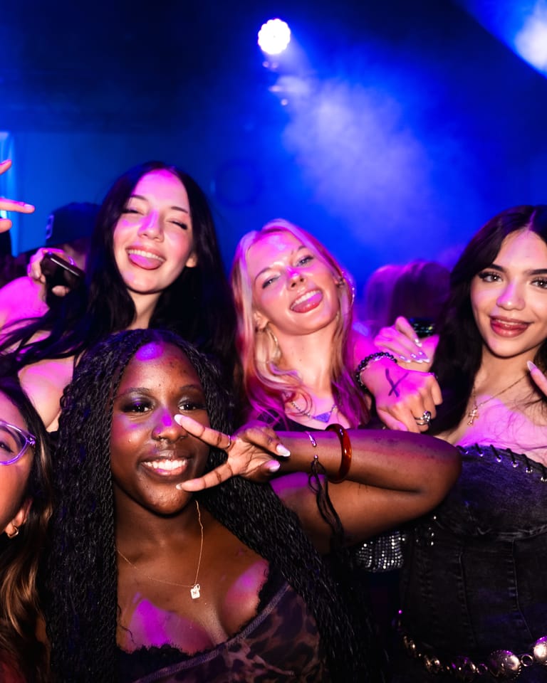Friends throwing peace signs at the CTRL wall