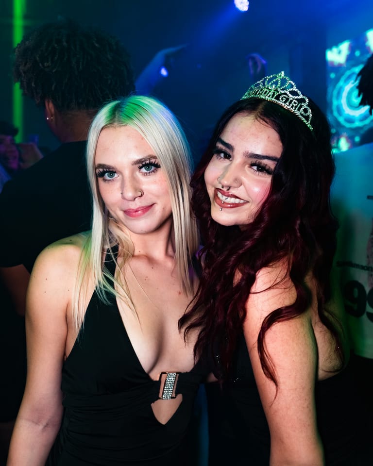 Two friends celebrating a birthday, one in a tiara