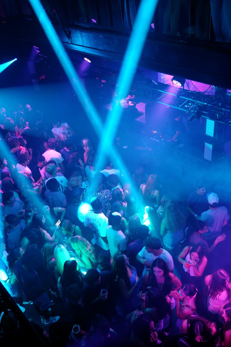 Cyan beams crossing over the crowd