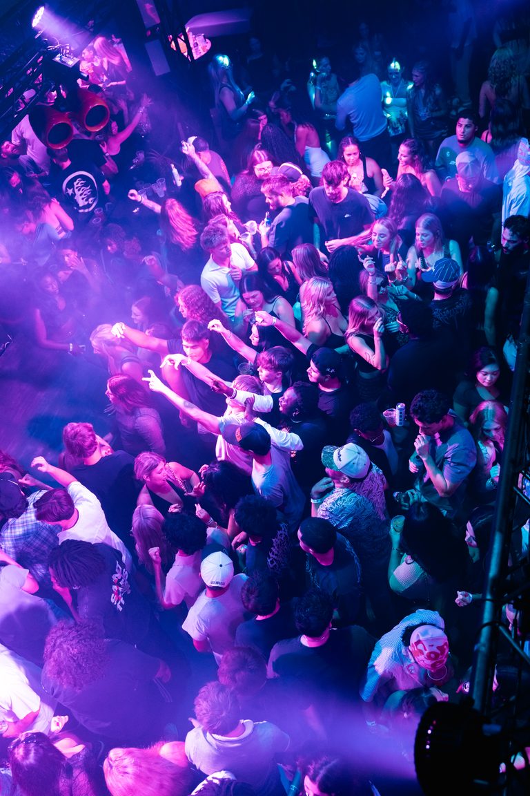 Purple haze and raised hands, seen from above