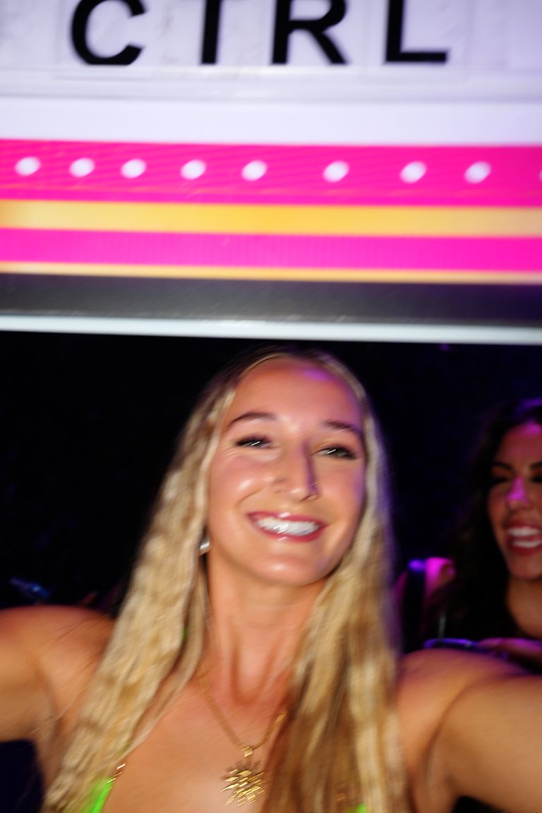A host carrying the lit CTRL marquee sign to a VIP section